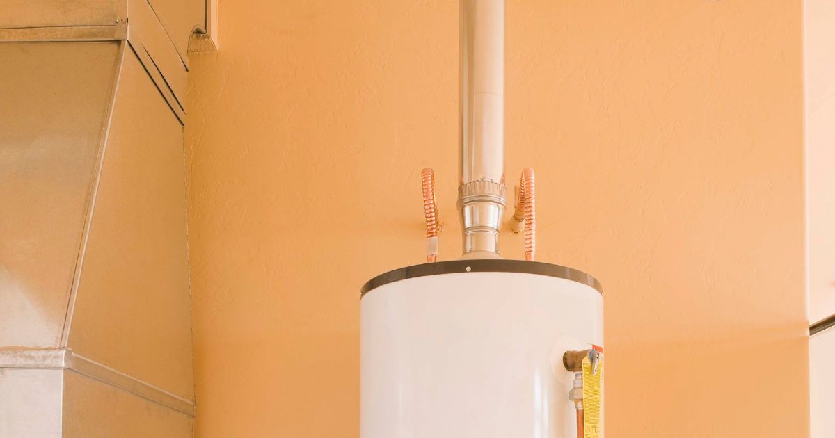 a flue coming out of the top of a water heater in front of a light orange wall Mid-Valley Chimney Repair